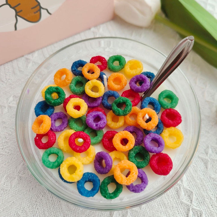 VibeCore Cereal Bowl Candle styled with colorful Froot Loops-shaped wax pieces in a milky soy base, mimicking a playful cereal bowl.