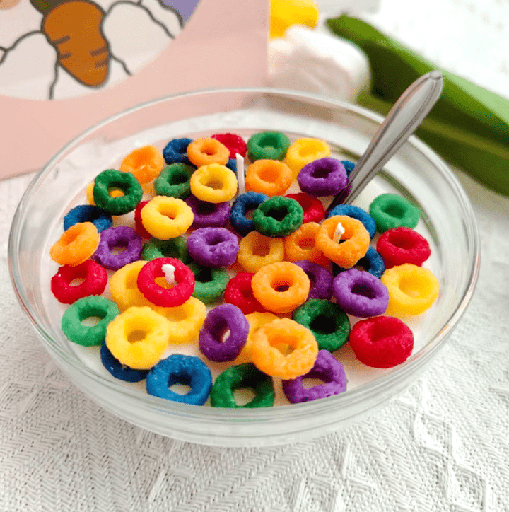 Close-up of VibeCore Cereal Bowl Candle featuring vibrant Froot Loops wax pieces and a glossy soy wax base, resembling a real bowl of cereal.