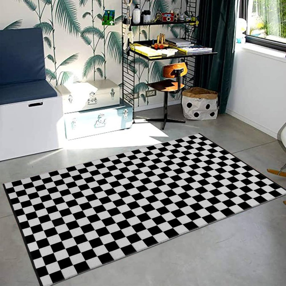 VibeCore Checkerboard Area Rug in Black on the floor, featuring a bold black and white checkerboard pattern that adds a modern, stylish touch to the space.