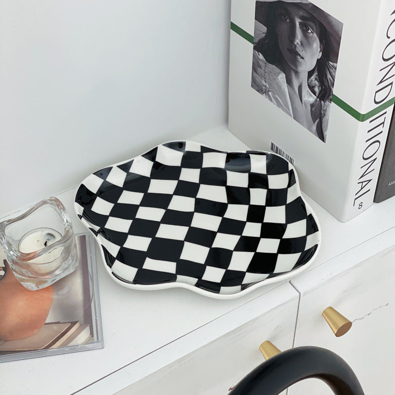 Aesthetic checkerboard display tray in black on a shelf featuring a striking hand-painted porcelain design perfect for adding modern simplicity to your space while serving as a stylish display piece.