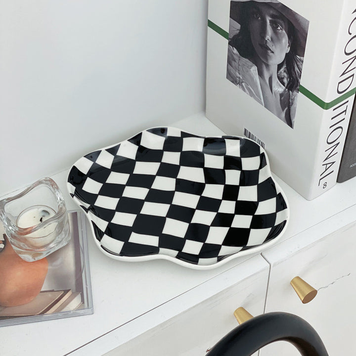 Aesthetic checkerboard display tray in black on a shelf featuring a striking hand-painted porcelain design perfect for adding modern simplicity to your space while serving as a stylish display piece.