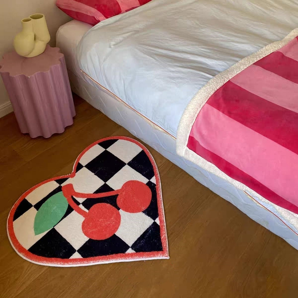 VibeCore Cherry Chessboard Accent Rug placed beside the bed, featuring playful cherry designs and classic chessboard patterns. Soft, fluffy texture with a non-slip backing, adding comfort and style to your bedroom. Durable and easy to clean.