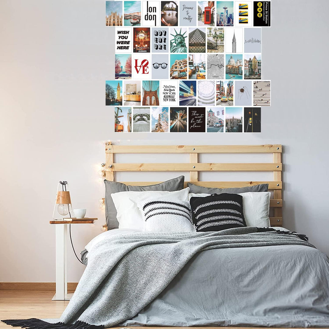 VibeCore City Girl Wall Collage Kit above bed featuring 50 trendy city prints capturing iconic landmarks and chic cityscapes. Perfect for dorm room, bedroom, travel decor, urban-inspired, wanderlust, modern aesthetic, and stylish city wall art.