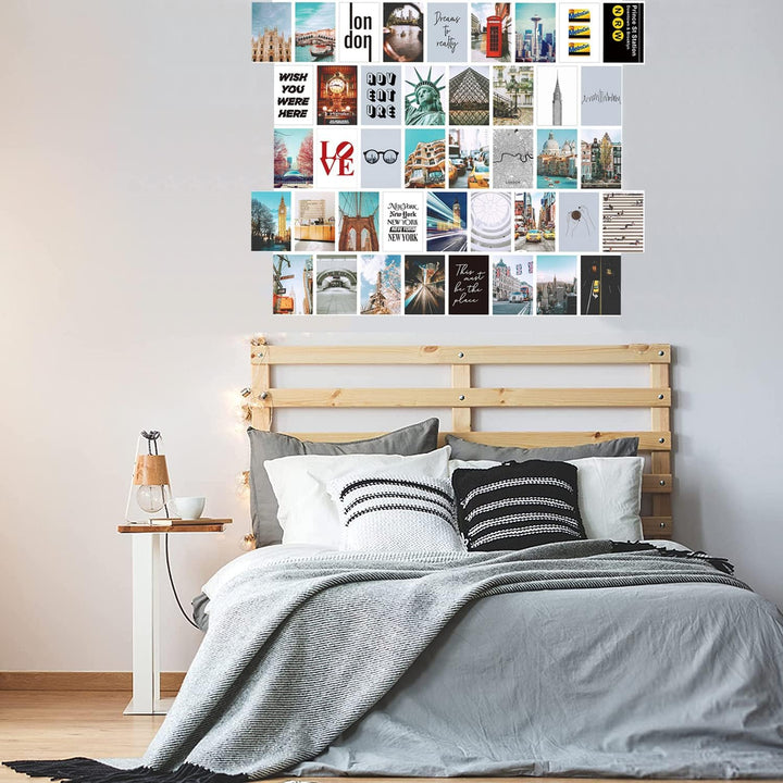 VibeCore City Girl Wall Collage Kit above bed featuring 50 trendy city prints capturing iconic landmarks and chic cityscapes. Perfect for dorm room, bedroom, travel decor, urban-inspired, wanderlust, modern aesthetic, and stylish city wall art.