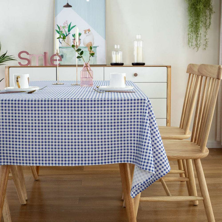 VibeCore Classic Picnic Plaid Tablecloth blue corner view, featuring a vibrant plaid pattern, waterproof, fade-resistant fabric, ideal for stylish gatherings and outdoor events.