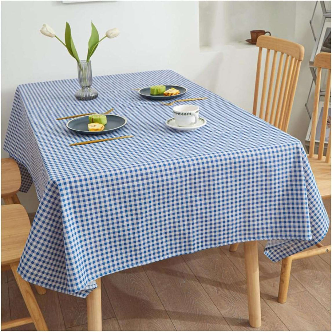 VibeCore Classic Picnic Plaid Tablecloth blue on table, showcasing a vibrant plaid design with waterproof, fade-resistant fabric, perfect for stylish table settings at any gathering.