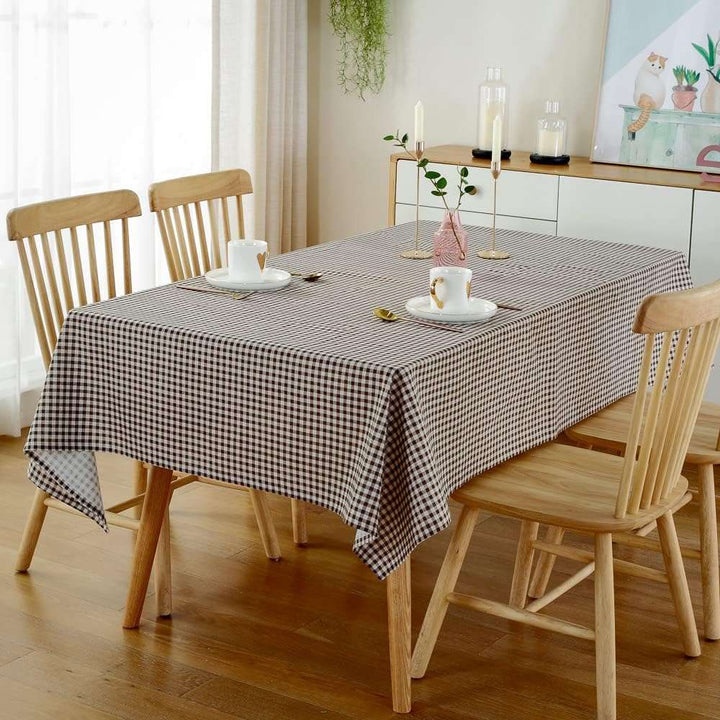 VibeCore Classic Picnic Plaid Tablecloth brown on table, showcasing a vibrant plaid design with waterproof, fade-resistant fabric, perfect for stylish table settings at any gathering.