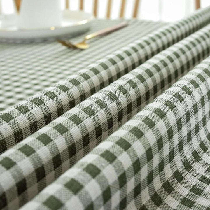 VibeCore Classic Picnic Plaid Tablecloth dark green close up, highlighting the vibrant plaid pattern and smooth, fade-resistant fabric, perfect for adding charm to any table setting.