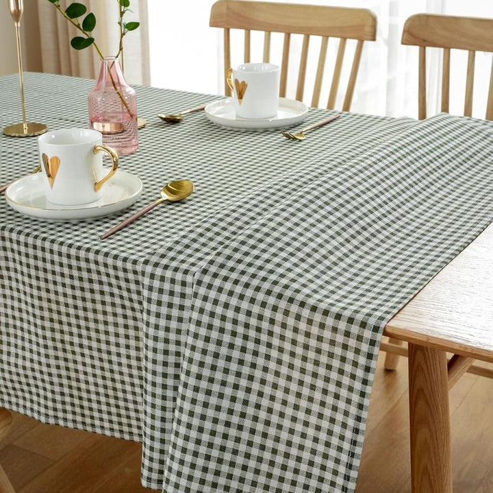 VibeCore Classic Picnic Plaid Tablecloth dark green on table, showcasing a vibrant plaid design with waterproof, fade-resistant fabric, perfect for stylish table settings at any gathering.