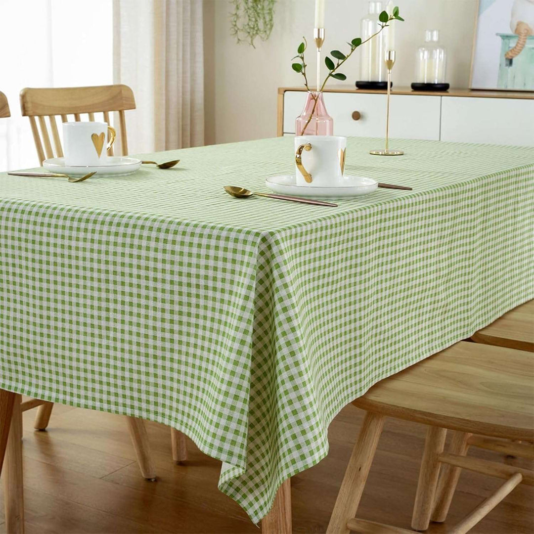 VibeCore Classic Picnic Plaid Tablecloth green corner view, featuring a vibrant plaid pattern, waterproof, fade-resistant fabric, ideal for stylish gatherings and outdoor events.