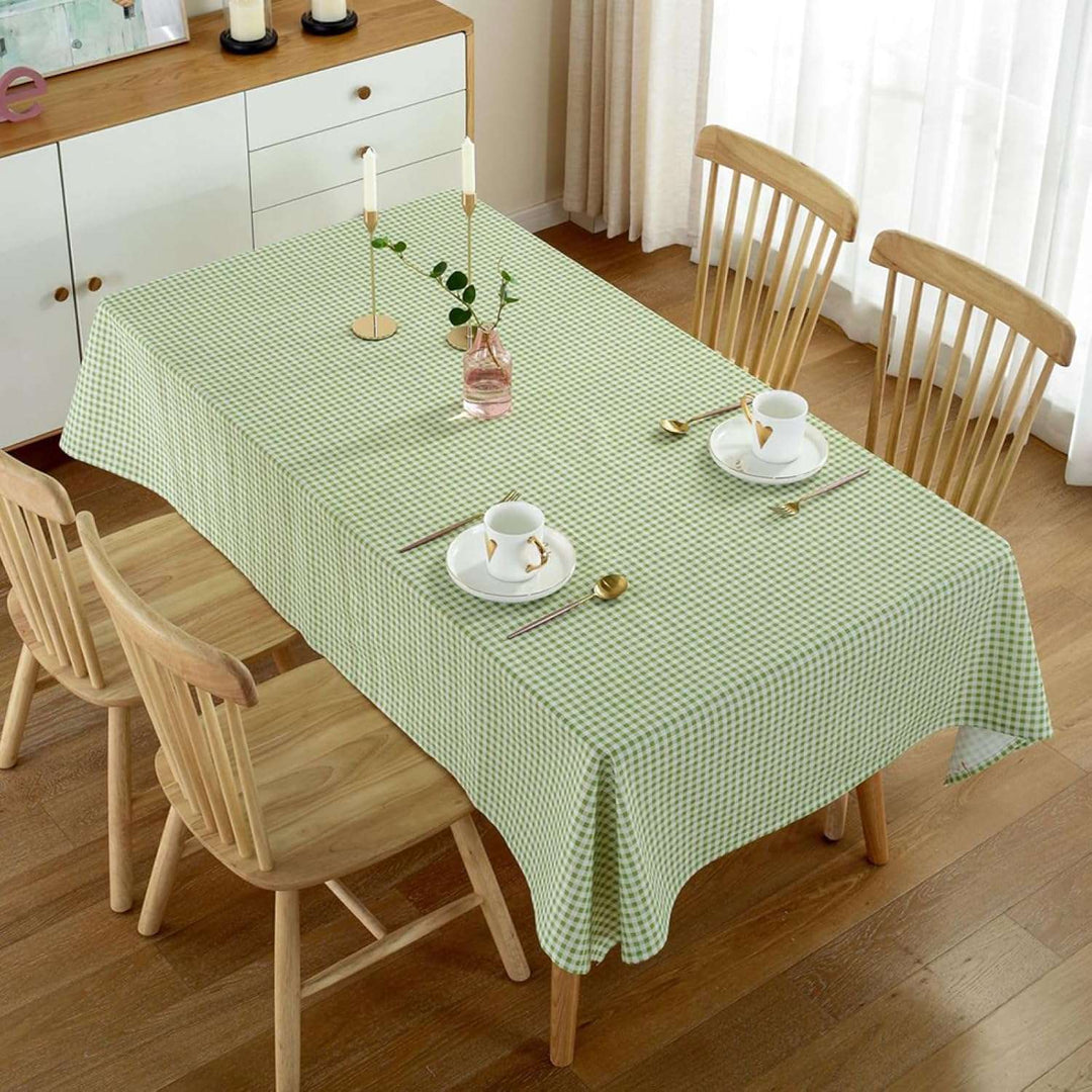 VibeCore Classic Picnic Plaid Tablecloth green on table, showcasing a vibrant plaid design with waterproof, fade-resistant fabric, perfect for stylish table settings at any gathering.