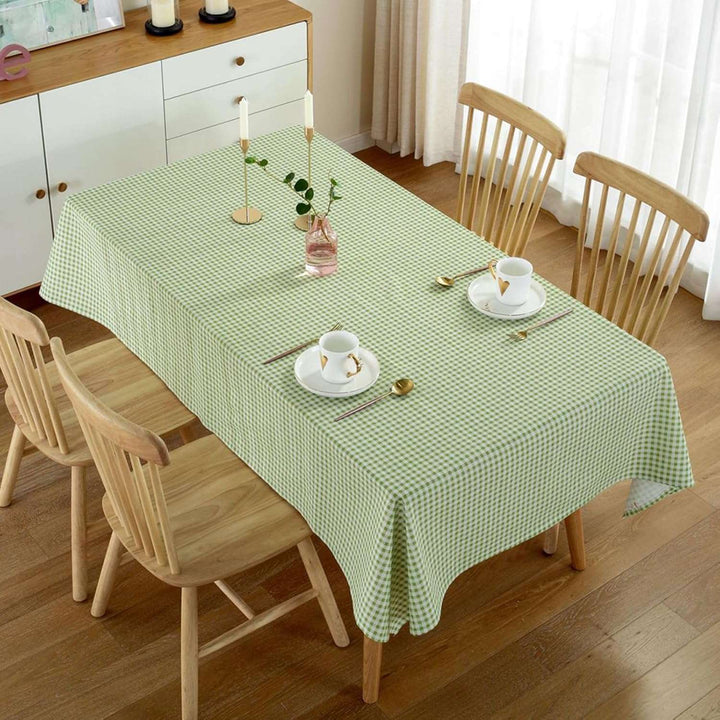 VibeCore Classic Picnic Plaid Tablecloth green on table, showcasing a vibrant plaid design with waterproof, fade-resistant fabric, perfect for stylish table settings at any gathering.