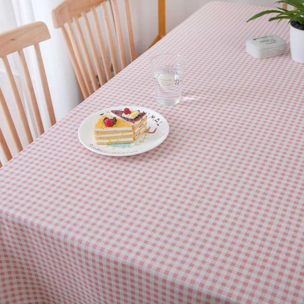 VibeCore Classic Picnic Plaid Tablecloth light pink close up, highlighting the vibrant plaid pattern and smooth, fade-resistant fabric, perfect for adding charm to any table setting.