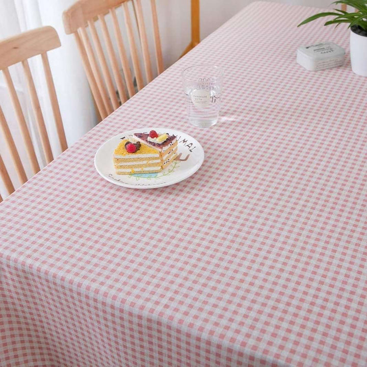 VibeCore Classic Picnic Plaid Tablecloth light pink close up, highlighting the vibrant plaid pattern and smooth, fade-resistant fabric, perfect for adding charm to any table setting.