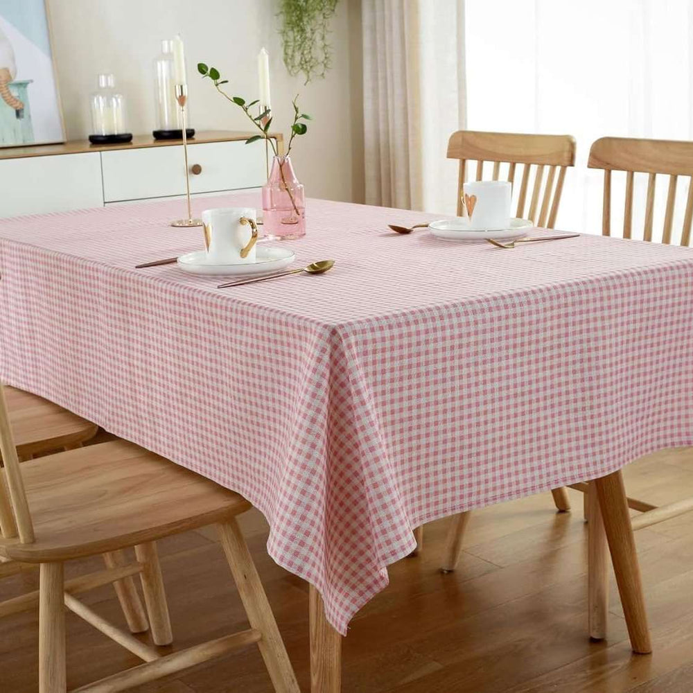 VibeCore Classic Picnic Plaid Tablecloth light pink corner view, featuring a vibrant plaid pattern, waterproof, fade-resistant fabric, ideal for stylish gatherings and outdoor events.