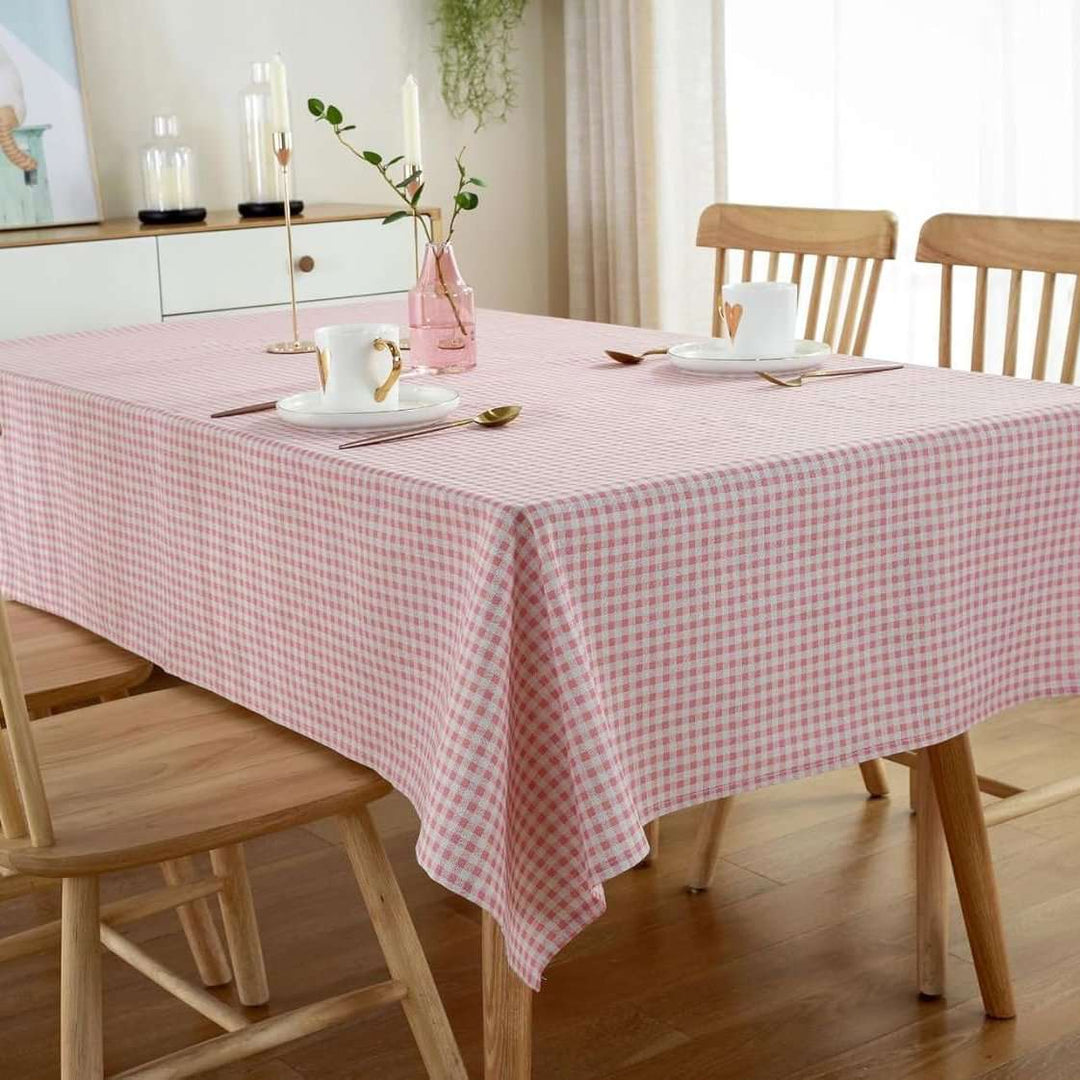 VibeCore Classic Picnic Plaid Tablecloth light pink corner view, featuring a vibrant plaid pattern, waterproof, fade-resistant fabric, ideal for stylish gatherings and outdoor events.