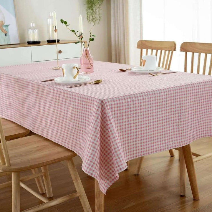 VibeCore Classic Picnic Plaid Tablecloth light pink corner view, featuring a vibrant plaid pattern, waterproof, fade-resistant fabric, ideal for stylish gatherings and outdoor events.