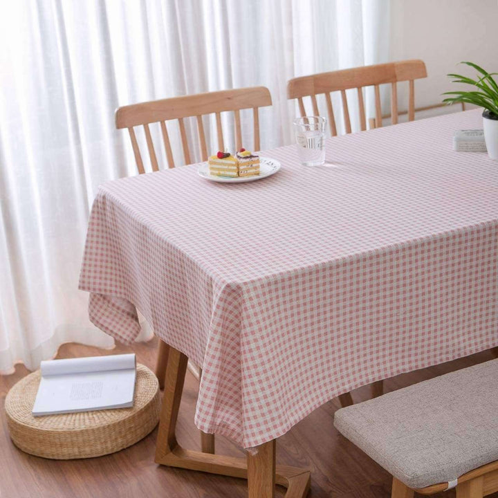 VibeCore Classic Picnic Plaid Tablecloth light pink on table, showcasing a vibrant plaid design with waterproof, fade-resistant fabric, perfect for stylish table settings at any gathering.