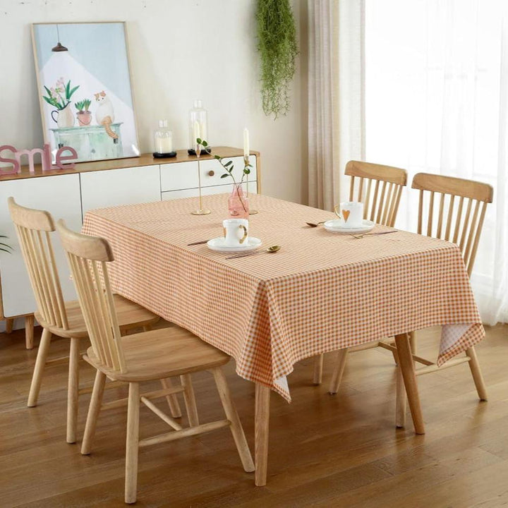 VibeCore Classic Picnic Plaid Tablecloth orange corner view, featuring a vibrant plaid pattern, waterproof, fade-resistant fabric, ideal for stylish gatherings and outdoor events.