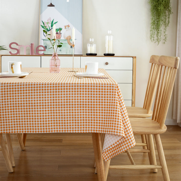 VibeCore Classic Picnic Plaid Tablecloth orange side view, showcasing a vibrant plaid design, waterproof, fade-resistant fabric, and perfect for stylish gatherings.