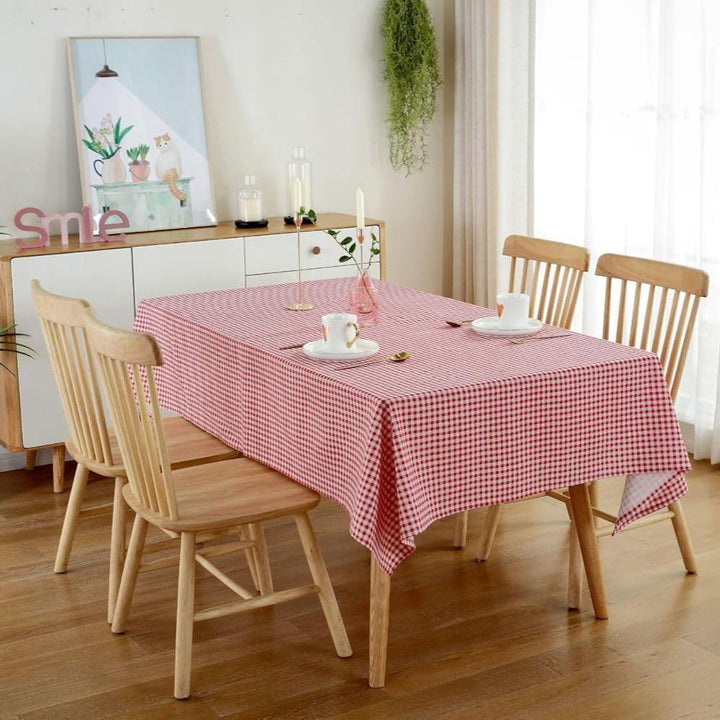 VibeCore Classic Picnic Plaid Tablecloth red on table, showcasing a vibrant plaid design with waterproof, fade-resistant fabric, perfect for stylish table settings at any gathering.