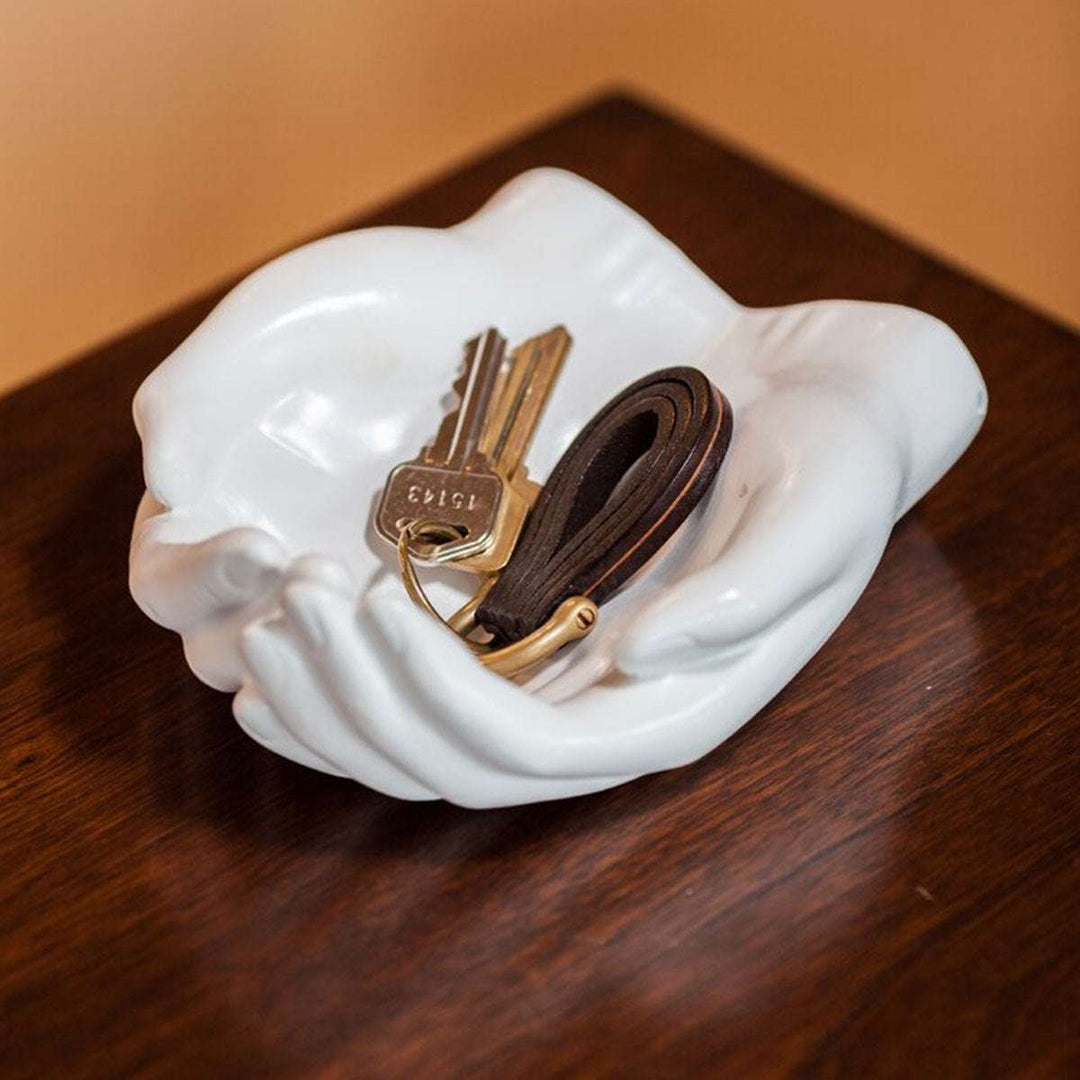 The VibeCore Closed Hands Display Tray, featuring a sleek white design with a closed hands shape, perfect for displaying jewelry, keys, or small treasures while adding a unique touch to any space.