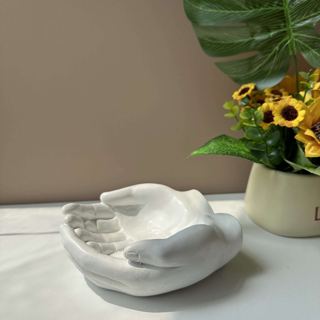 Side view of the VibeCore Closed Hands Display Tray, showcasing its elegant white poly resin design and smooth contours.