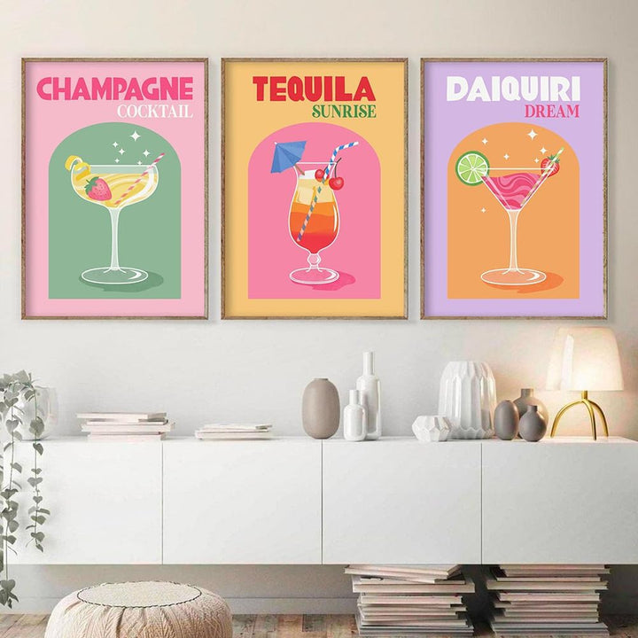 Framed colorful cocktails canvas posters on a wall, showcasing vibrant digital art of drinks like Champagne Cocktail, Tequila Sunrise, and Daiquiri Dream, adding a lively and stylish touch to the space.