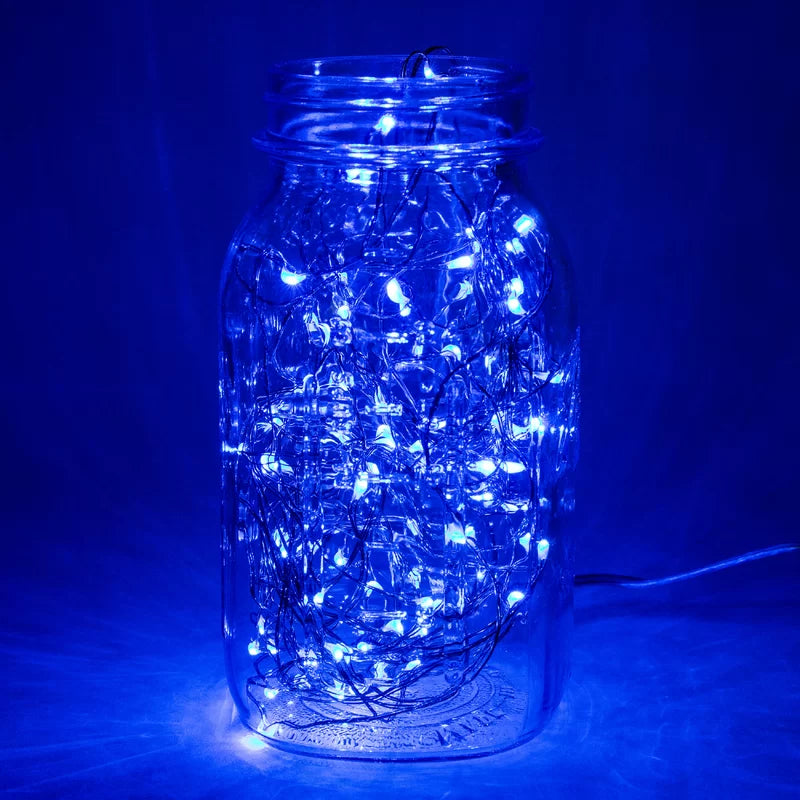 VibeCore copper fairy lights in blue, placed inside a jar, creating a serene and cozy ambiance with a soft, calming glow.