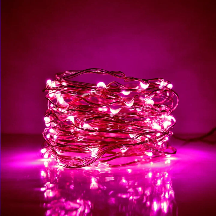 VibeCore copper fairy lights in pink, creating a soft, vibrant glow to brighten any room with a cozy, colorful ambiance.
