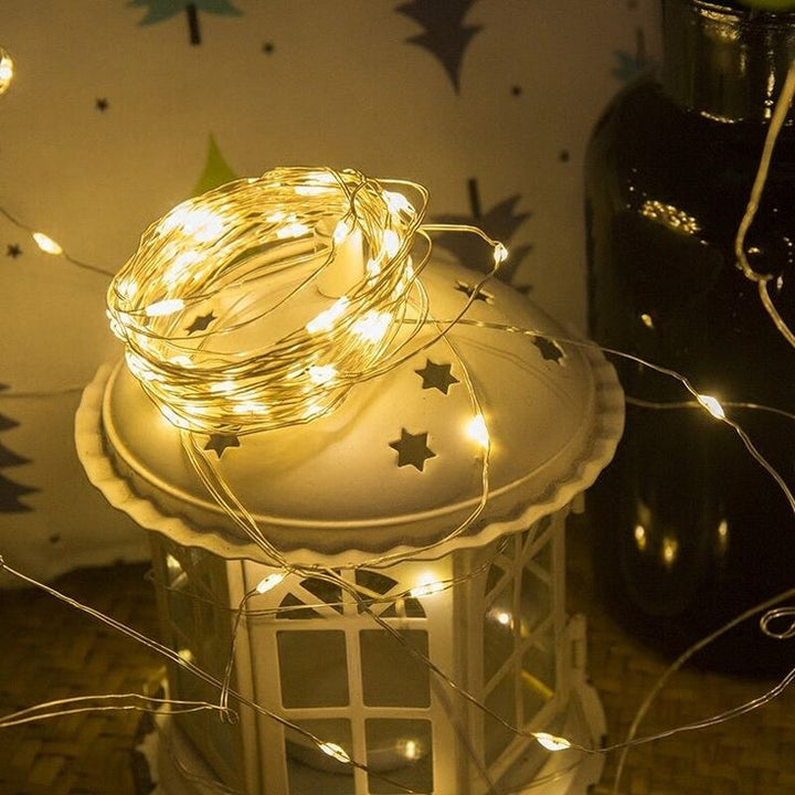 VibeCore copper fairy lights in warm white, glowing softly in the room, creating a cozy and inviting atmosphere.