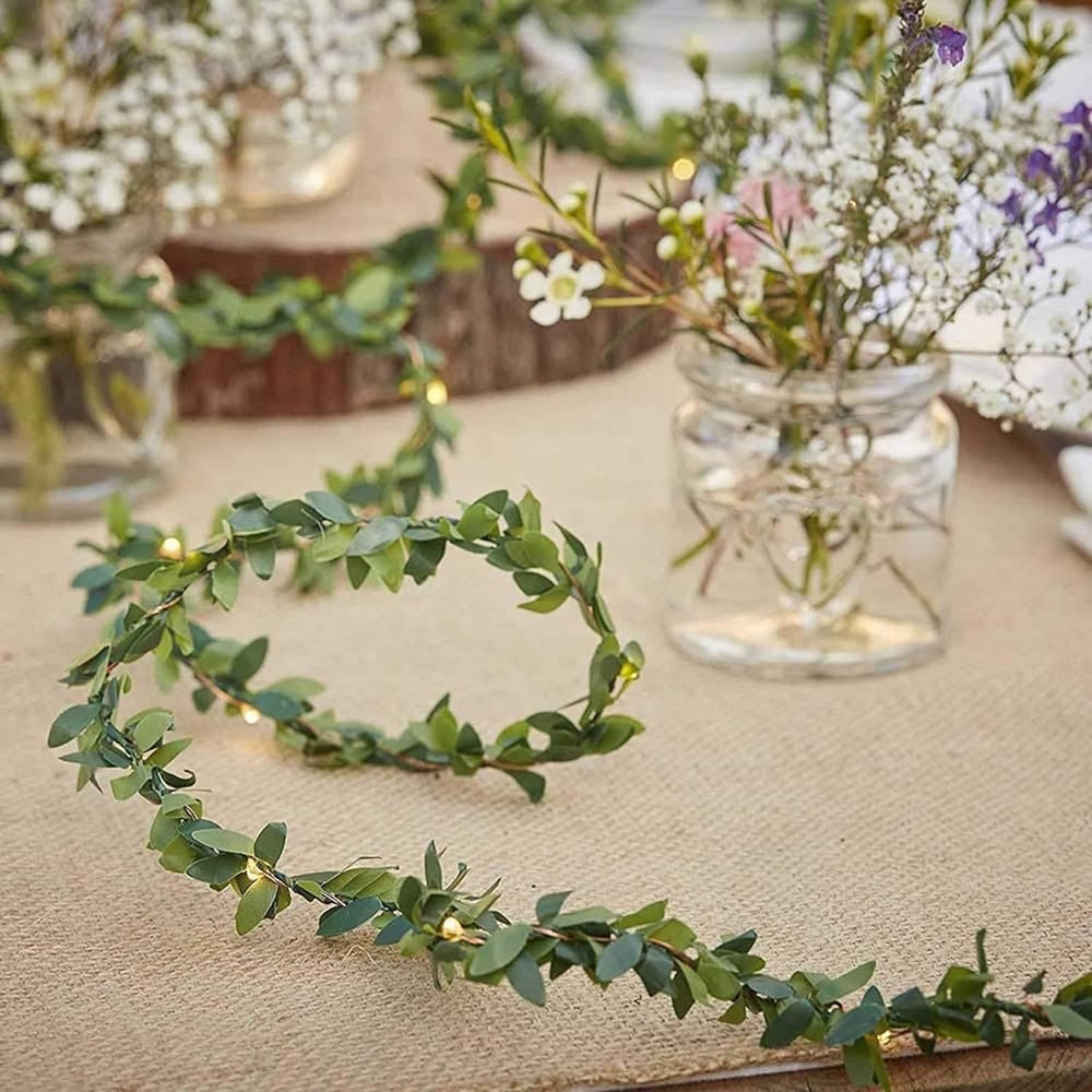 Close-up of VibeCore copper leaf garland string lights, showcasing the 100 warm white LEDs intertwined with lush, artificial leaves for a cozy, vibrant glow.