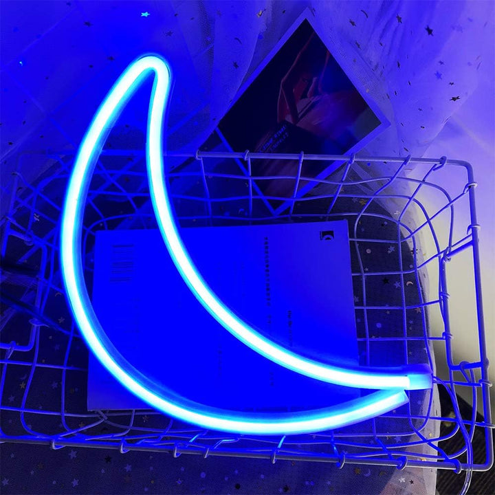 VibeCore Crescent Moon Neon Light Blue, glowing softly with a serene blue light, creating a calming and mystical ambiance in the room.