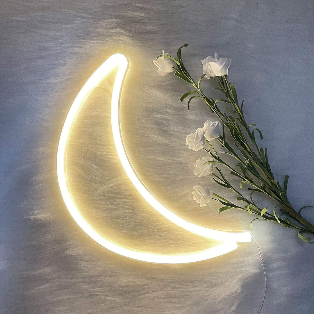 VibeCore Crescent Moon Neon Light Warm White lying down on a flat surface, casting a soft, warm glow.