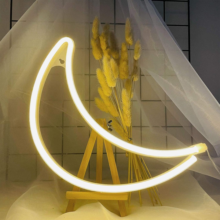 VibeCore Crescent Moon Neon Light Warm White on a stand, glowing softly in a calming, warm white light.