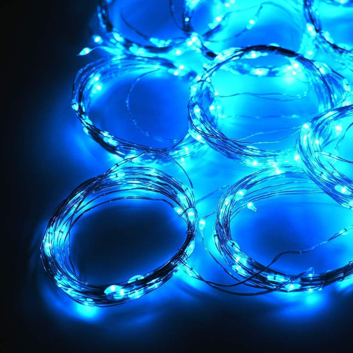 Close-up of blue curtain string lights, glowing with a cool, ambient light.
