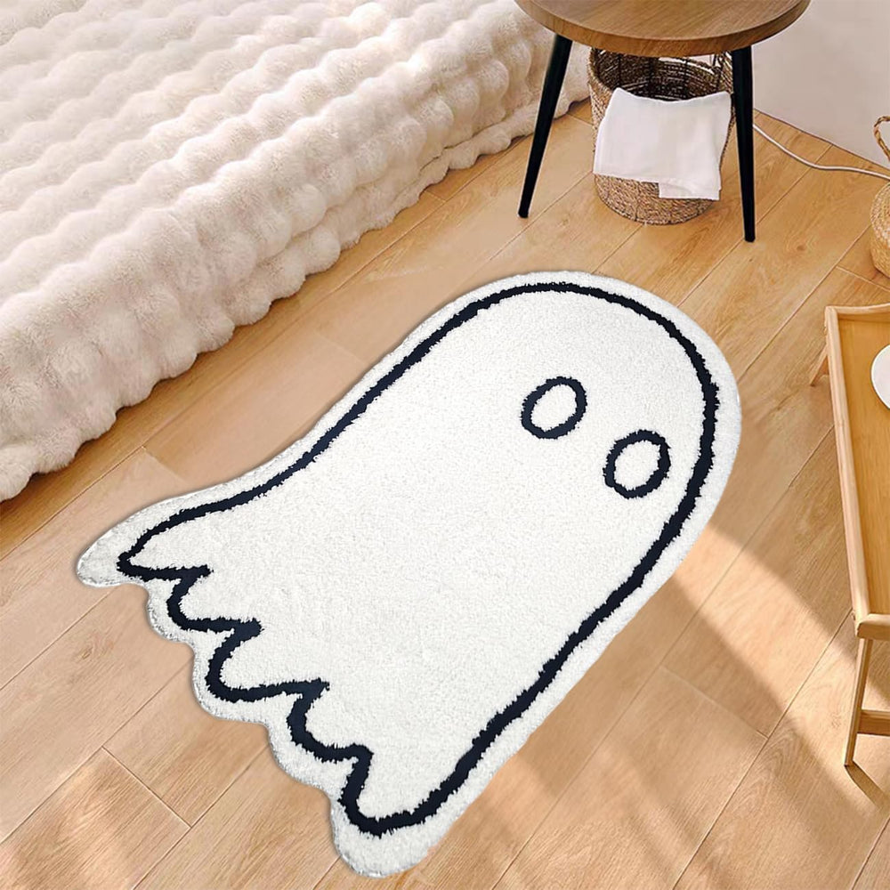 VibeCore Cute Ghost Accent Rug beside a bed, angled aerial view, showcasing its playful ghost design and plush texture, adding a fun, whimsical touch to the room with black and white colors.