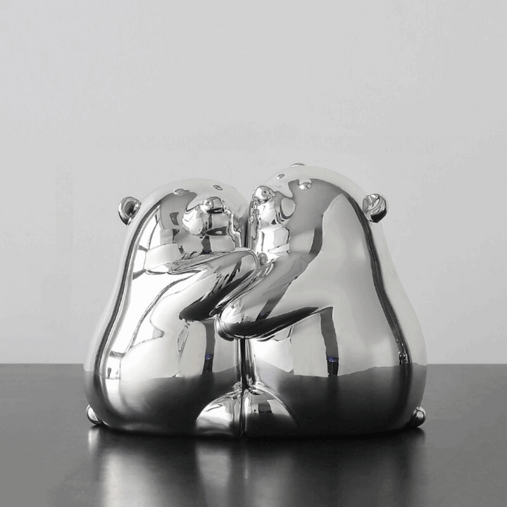 VibeCore Cute Hugging Bears Bookends with two silver noses, providing a playful and sturdy support for books on a shelf.