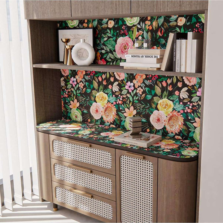 A view of the dark watercolor floral self-adhesive wallpaper as the backdrop behind a shelf, adding an artistic and modern touch to the space while highlighting the floral pattern.