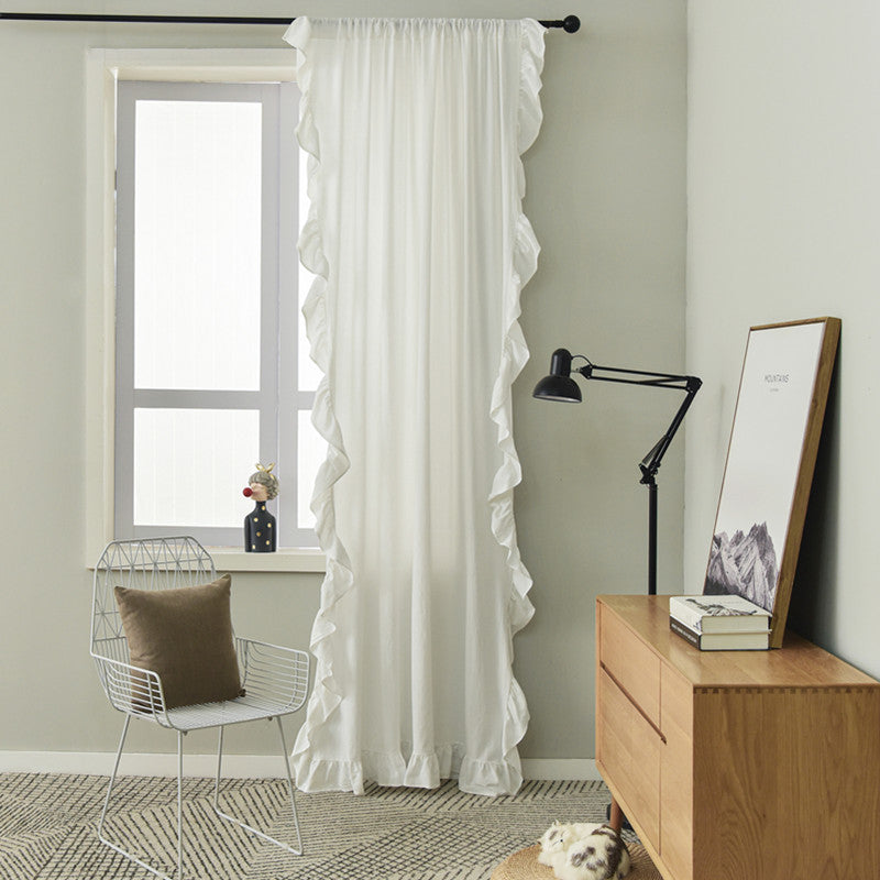 VibeCore Delicate Ruffles Curtain in white, showcasing soft fabric with intricate ruffle detailing, hanging in a sunlit room.