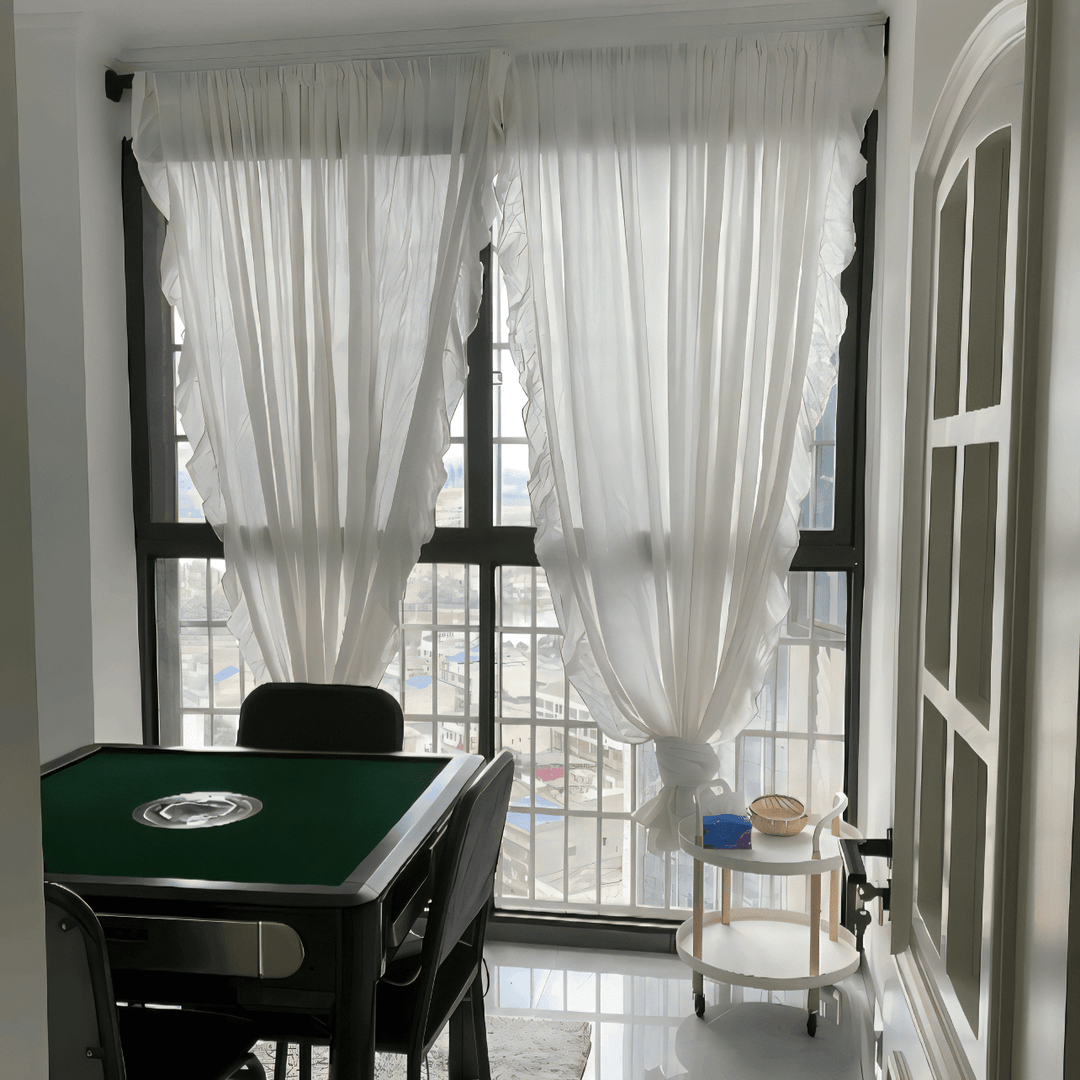 VibeCore Delicate Ruffles Curtain in white hanging in a bright apartment, creating a soft, bohemian atmosphere with its semi-sheer fabric and ruffle detailing.