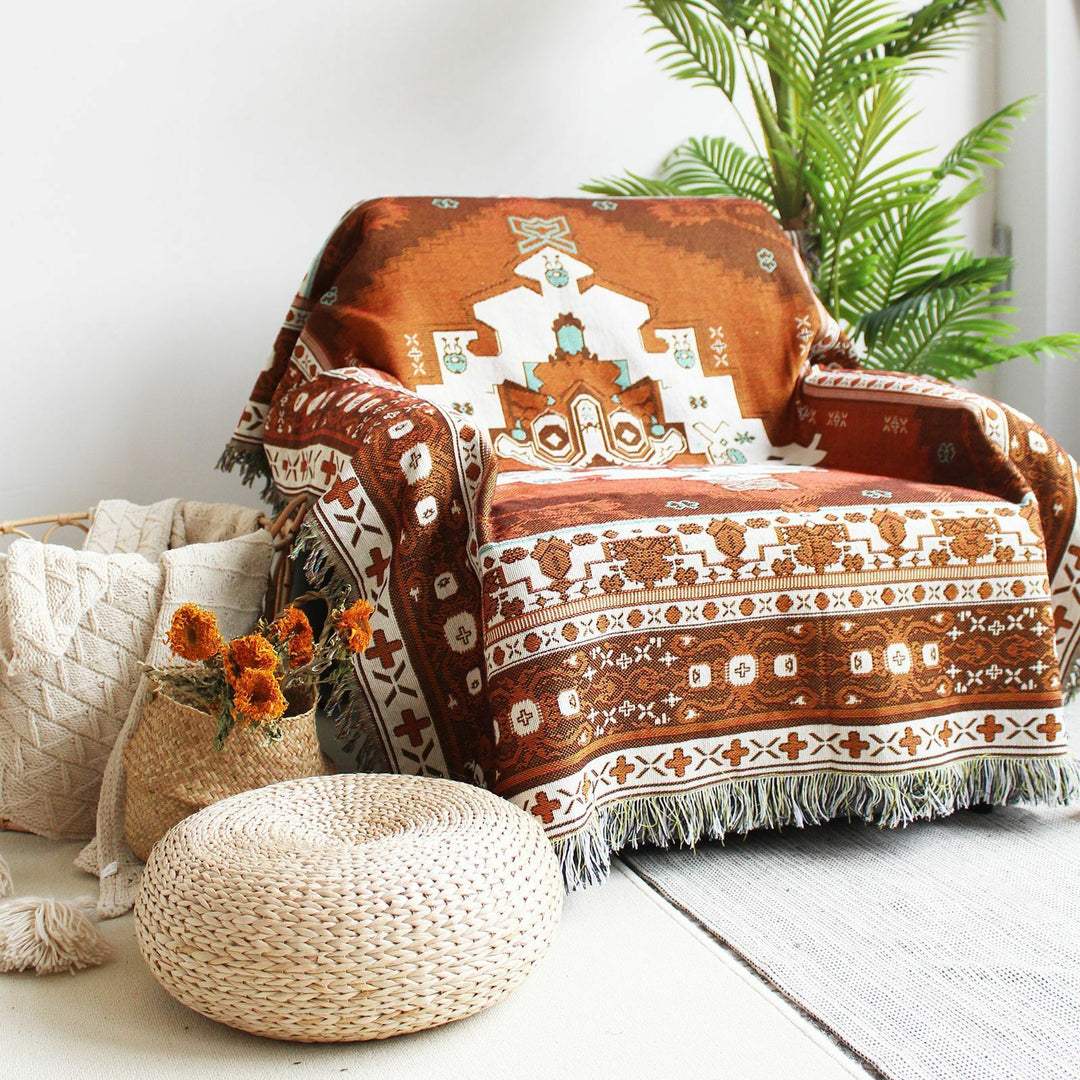 VibeCore Desert Mirage Woven Blanket draped over chair - reversible boho cotton throw with tribal geometric pattern for cozy home decor