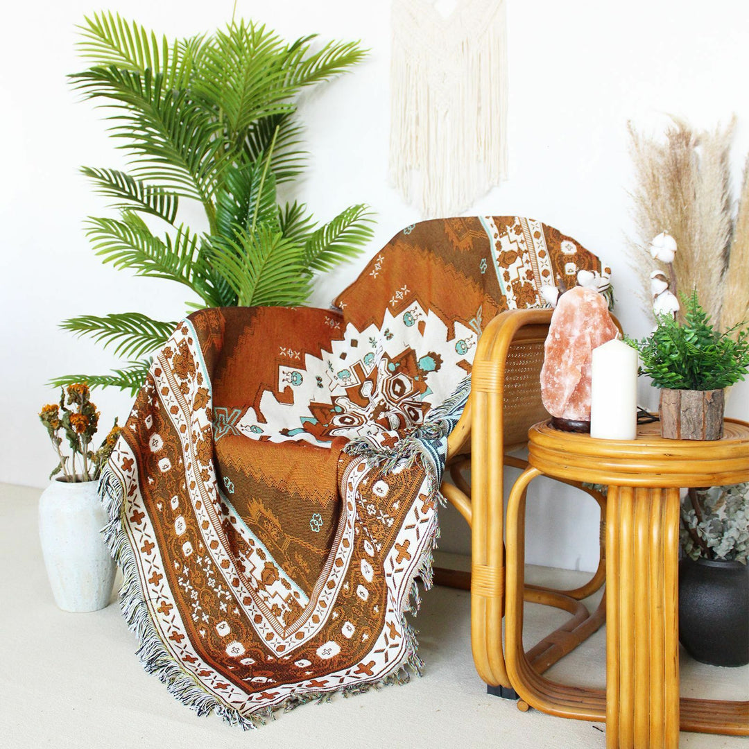 VibeCore Desert Mirage Woven Blanket draped over chair - reversible boho cotton throw with tribal pattern for stylish home decor alternative angle