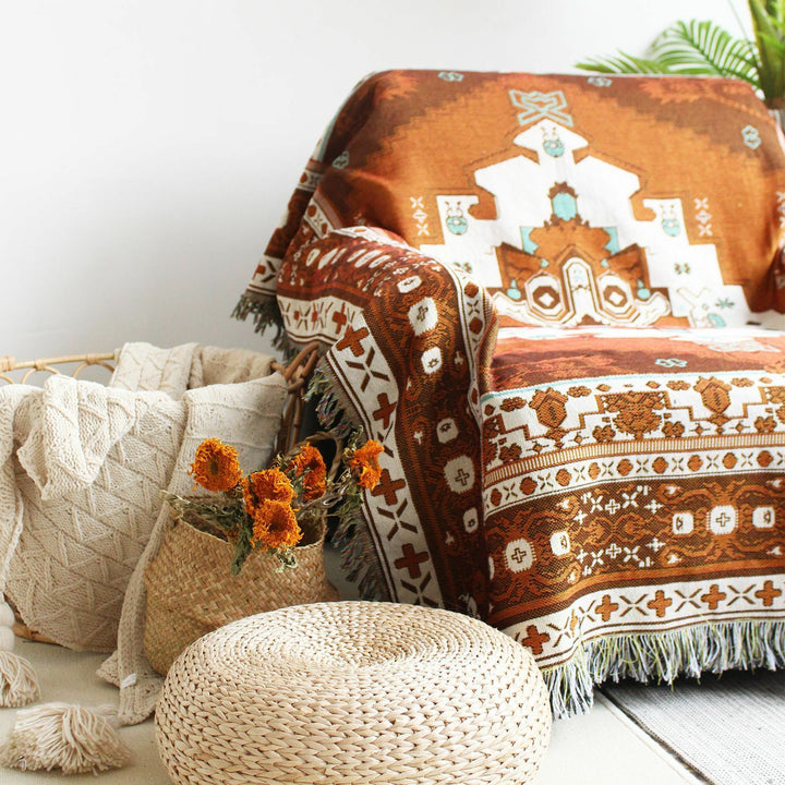 VibeCore Desert Mirage Woven Blanket close-up on chair - textured reversible boho cotton throw with vibrant tribal pattern details