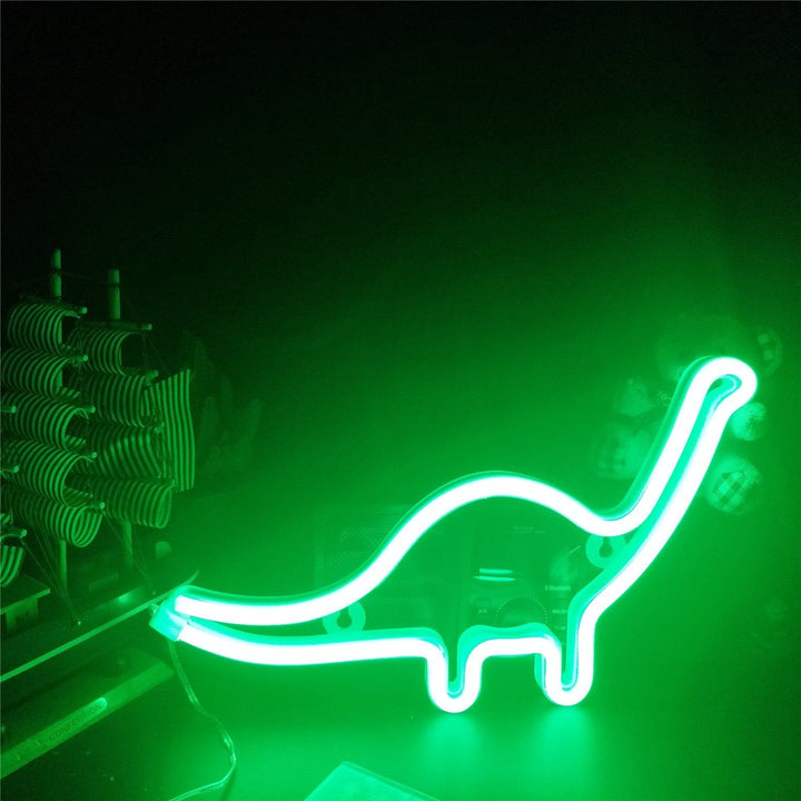 Aesthetic VibeCore Dinosaur Neon Light on a desk, USB or battery-powered LED sign for trendy bedroom, dorm, or game room decor, adding a fun, bold glow to elevate your space.