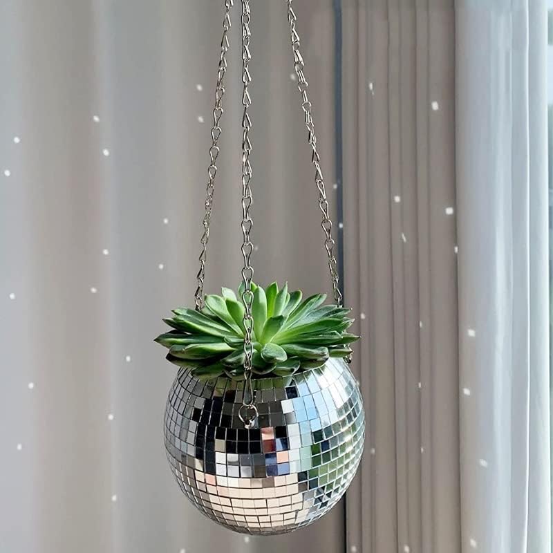 VibeCore Disco Ball Planter hanging by the window, showcasing its fun, retro mirror-ball surface. This unique planter adds a sparkly, reflective touch to any space while serving as a functional hanging pot for your favorite plants. Perfect for bringing a party-ready atmosphere and retro vibe to your living room, bedroom, or office.