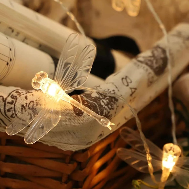 VibeCore Dragonfly String Lights close-up, showcasing delicate dragonfly designs glowing with soft, warm white light.