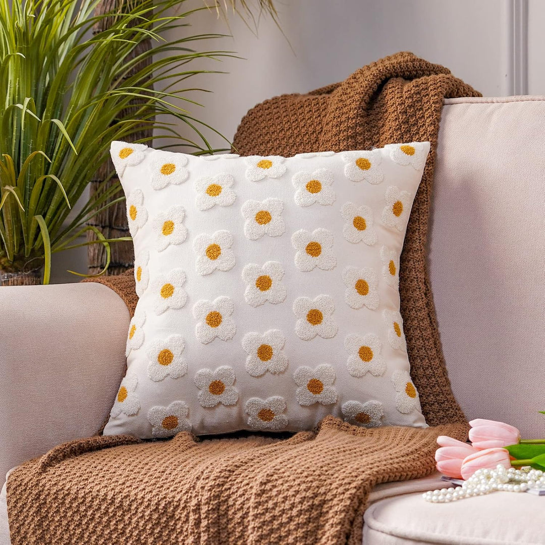 White square throw pillow covers with hand-stitched embroidered daisies, showcasing a fresh and floral design. Made from soft, breathable cotton, these covers add a cozy and elegant touch to any space, featuring a concealed zipper for a polished look.