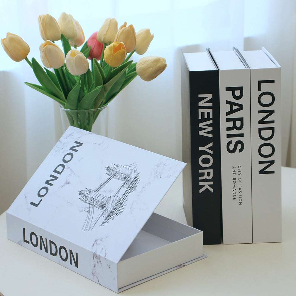 VibeCore Fashion Fake Book Storage Box on Desk, designed to look like a chic coffee table book, used for organizing small items like stationery or jewelry, adding a stylish touch to a workspace.