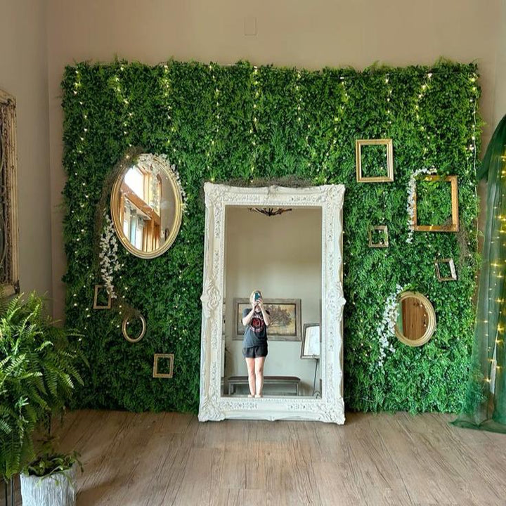 Aesthetic faux boxwood plant wall decoration on the wall behind a mirror featuring lush greenery and realistic texture perfect for indoor and outdoor decor low-maintenance and easy to install